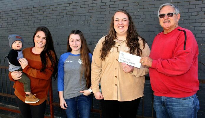 Brittany Aubuchon &amp; Drew of Main Street Mercantile, Bree Allgier of Reed’s Relics and Lindsey Harmon of Lou Lou’s presented a $900 donation to Potosi Elks representative Randy Eaton