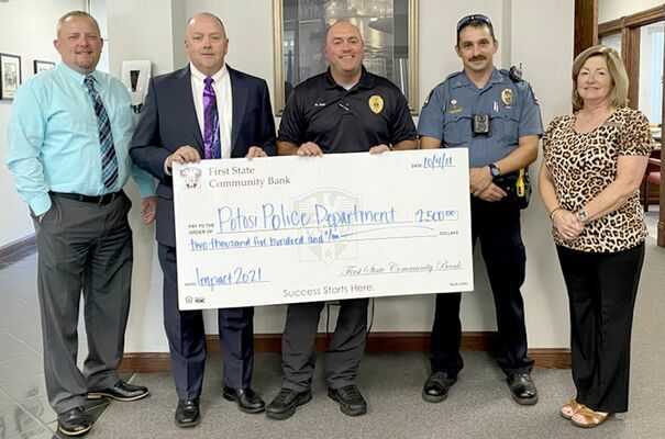 From left, presenting the grant were Blake Yount, Asst. V.P.; Don Thompson, Pres.; and Donna Coffman, Teller for F.S.C.B., accepted by Chief of Police Mike Gum and Officer Casey Price