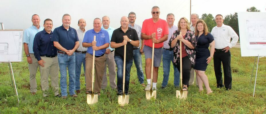 The group here includes, from left, at front with shovels, Charlie Grissom, JayCee Dental; Don Thompson, County I.D.A. President; Curtis Dzuba, Miracle Marine; and Krista Snyder, Director for the Industrial Development Authority; back, from left are Joe Gable, Taylor Engineering; Chris Horton, Marty Simpson, ,Craig Portell, I.D.A. Board Members; Presiding Commissioner Dave Sansegraw; 1st District Commissioner Doug Short; Alan Berry, A.B. CAD; Reggie Rowe, Vice President of the I.D.A. Board; Amy Eisenbeis and Chris McCaul of McCaul, McCaul &amp; Associates.